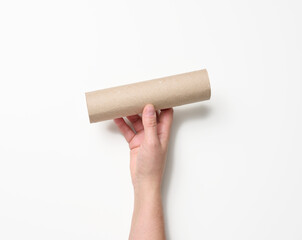 female hand holds a paper tube from under used napkins on a white background