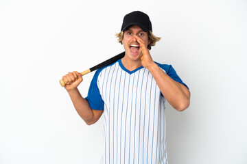 Young blonde man playing baseball isolated on white background shouting with mouth wide open