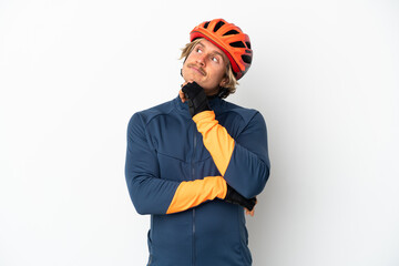 Young blonde cyclist man isolated on white background and looking up - obrazy, fototapety, plakaty