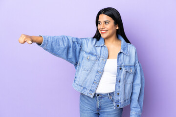 Young latin woman woman over isolated background giving a thumbs up gesture