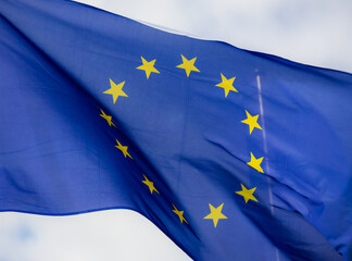 Official flag of the European Union in front of a blue sky