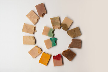 Handmade organic soaps on white background, top view.