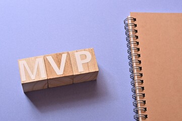 The word cubes formed MVP It's an abbreviation for Minimum Viable Product, with a notebook.