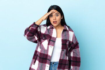 Young latin woman woman isolated on blue background has realized something and intending the...