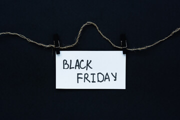 Black Friday text. Black background white sheet hand lettering marker on the rope. Conceptual...