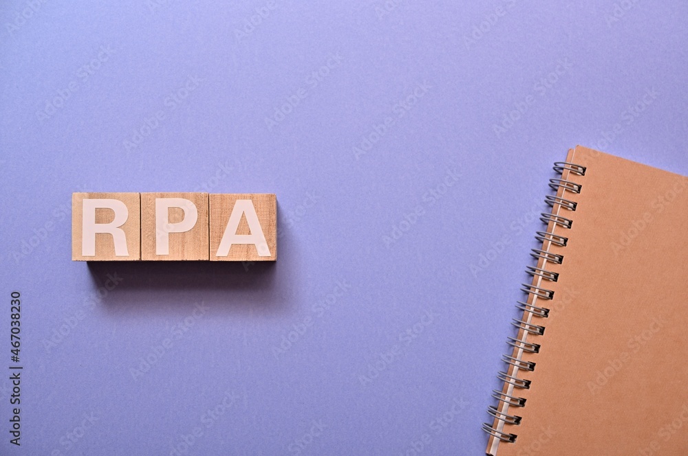 Poster the word cubes formed rpa it's an abbreviation for robotic process automation, with a notebook.