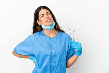 Dentist woman holding tools over isolated white background suffering from backache for having made an effort