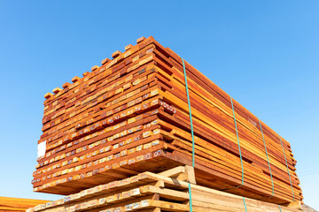 Pallet with a pile of lumber, packed for sale.