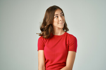 Obraz premium pretty woman in a red t-shirt hair care light background
