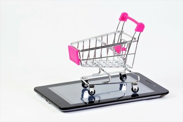 Shopping cart on the smartphone screen. The concept of planning shopping for consumer goods on the Internet, on weekdays and holidays of sales.