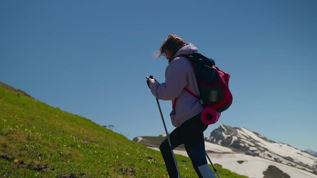 Woman mountain hiker using gps on mobile phone to check the route