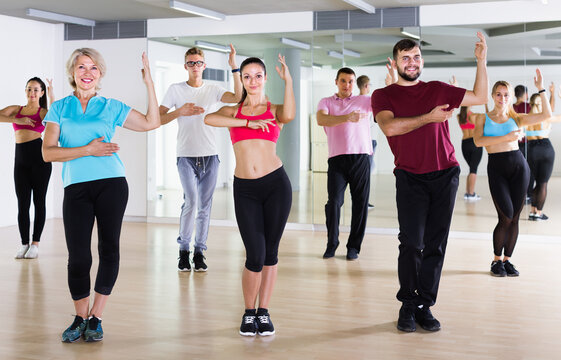 friendly people dancing aerobics at lesson in the dance class