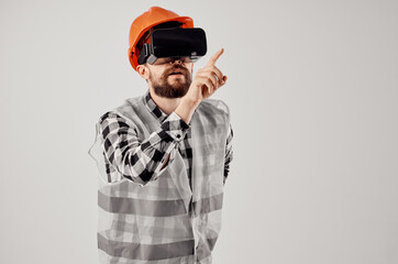male builder in virtual reality glasses innovation light background
