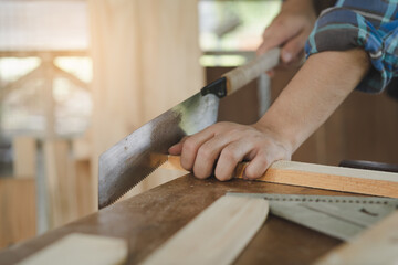 Carpentry professional, asian young man, male carpenter use machines or tool, knife saw to cut...