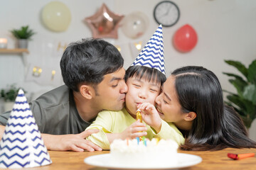 Happy birthday party in family, asian young parent father, mother and little cute boy or child...