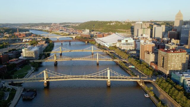 Aerial view towards the bridges in downtown Pittsburgh, sunny evening in USA - tilt, drone shot