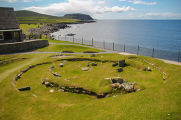 Stone Age house remains at the Jarlshof Prehistoric and Norse settlement in the Shetland Islands, Scotland, near the North Sea - obrazy, fototapety, plakaty