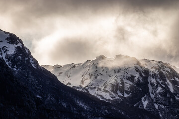 Fototapeta na wymiar Snowy mountain top with sunset light