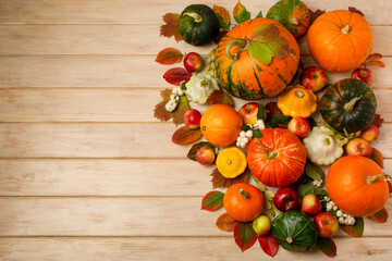 Thanksgiving arrangement with green, orange, striped pumpkins, copy space
