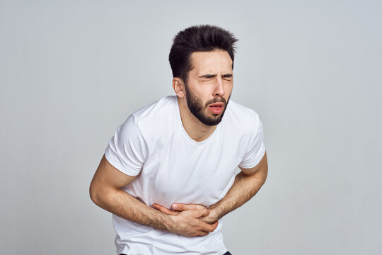 bearded man in white t-shirt posing gesturing with his hands