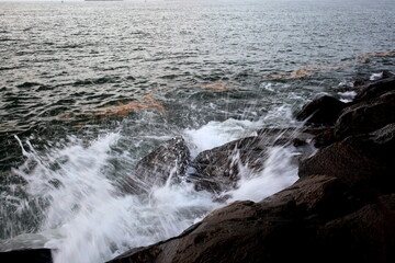 Long exposure of wave impacting on rocks on Karwar beach, Karnataka, India.