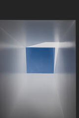 skylight or roof window with view of blue serene sky above and brand new plastered walls, concept of home improvements and architectural features