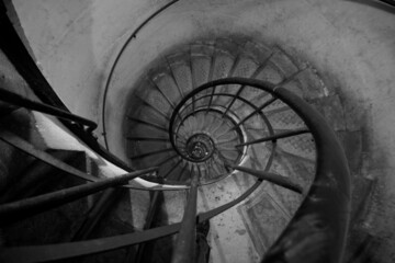 Downward spiral staircase in Black and White. 
Paris, France