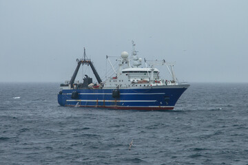 Fishing vessel floats in the sea.