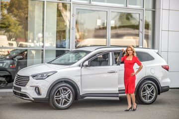 Confident woman standing near car outdoors
