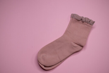 beautiful socks on a pink background, place for text

