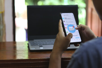 close up woman holding smartphone and checking email online on web with virtual interface technology concept