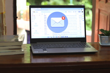New email alert on laptop, communication connection message to global letters in the workplace.