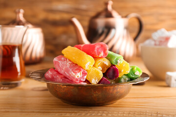 Plate with tasty Turkish delight on table