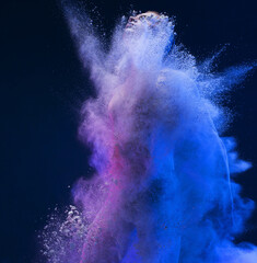 Male figure shot fully in a cloud of blue dust