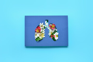 Paper lungs with flowers on blue background