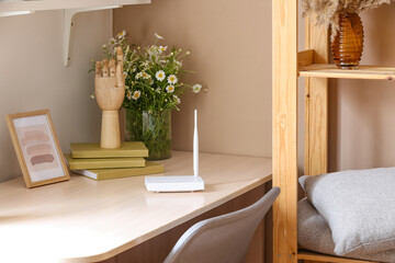 Modern wi-fi router on table in room