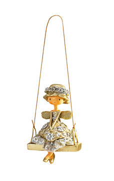 Christmas tree toy. Little fairy, sorceress in a hat and dress on a swing, isolated on white.