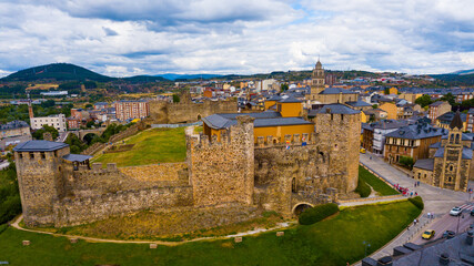 Fototapeta na wymiar Aerial view of ancient Templar castle in small Spanish city of Ponferrada on background of modern cityscape