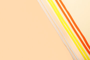 Different shoe laces on color background, closeup