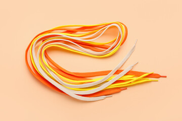 Many shoe laces on color background