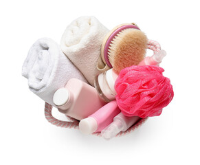 Basket with bath supplies, sponge and towels on white background