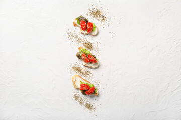 Delicious vegetarian bruschettas and spices on white background