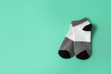 Pair of stylish socks on color background