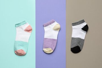 Different socks on color background