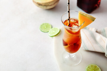 Glass with melon cocktail on light background
