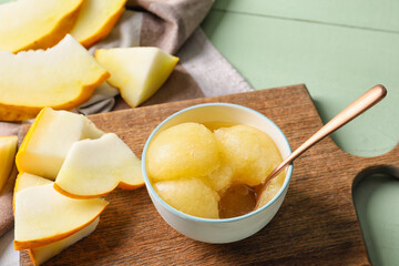 Bowl with tasty melon sorbet on color wooden background