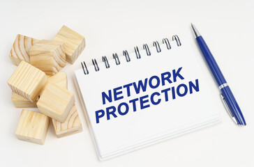On the table are cubes, a pen and a notebook with the inscription - network protection