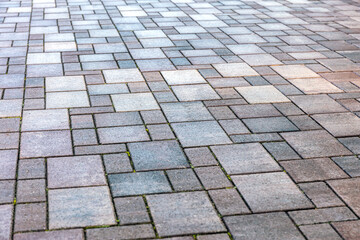 wet concrete block sidewalk after rain. grey modern pavement background texture.