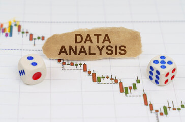 On the trading charts, there are dice and pieces of paper with the inscription - DATA ANALYSIS