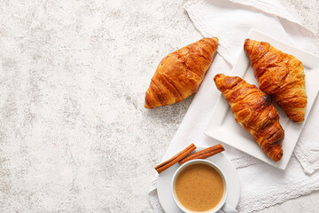 Plate with delicious croissants and cup of coffee on light background - Powered by Adobe